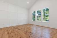 The master bedroom offers vaulted ceilings, beautiful natural light and custom trim accents.