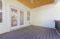 the upstairs covered porch features a tongue-and-groove ceiling, can lights and a ceiling fan.