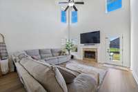Living room area with high ceilings and natural light.