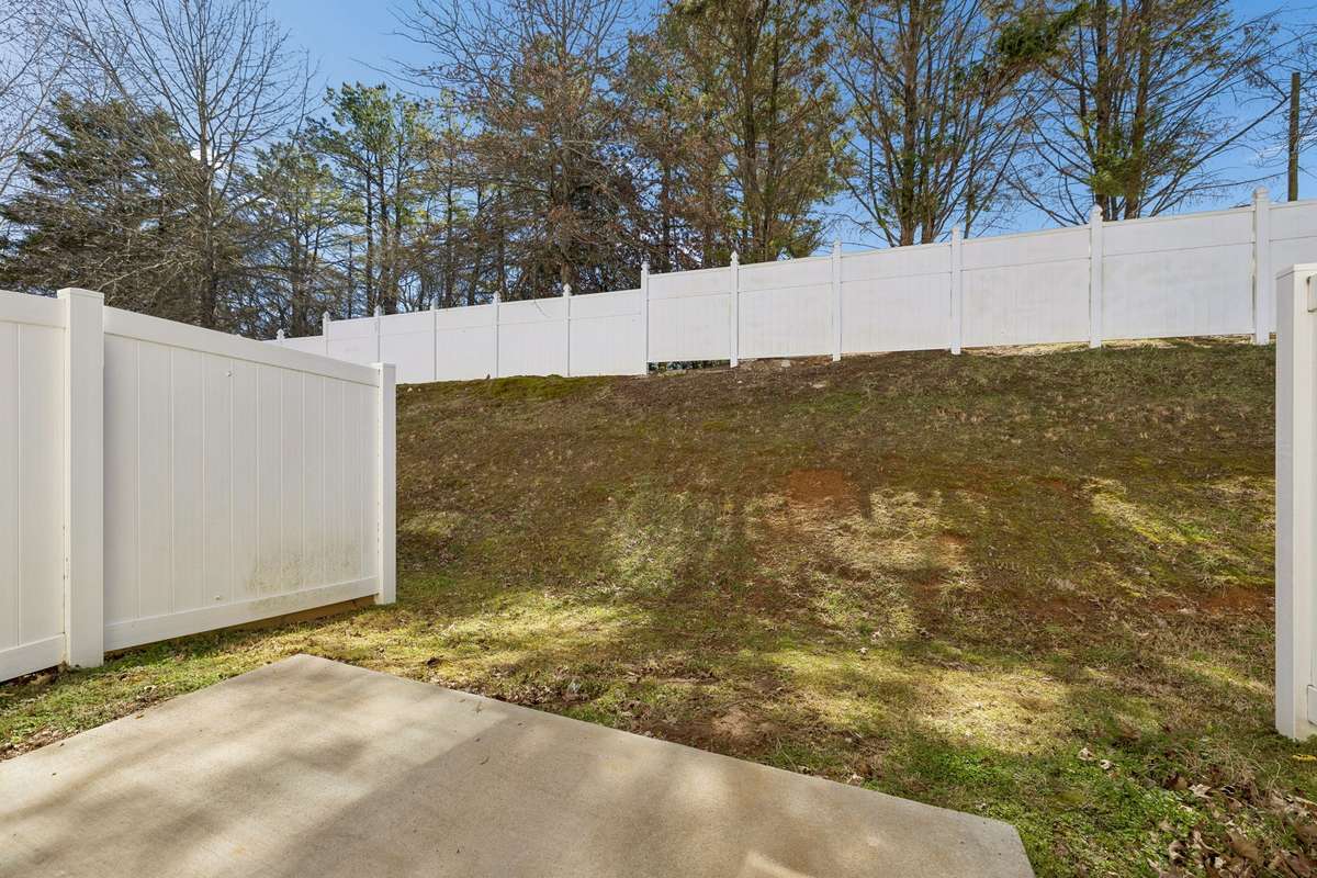 Private back porch setting, perfect for hosting gatherings or unwinding after a long day of work.
