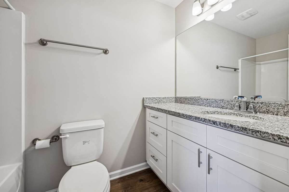 Primary Bathroom with spacious cabient spcae with soft-close drawer features, tall vanity, with granite countertops.
