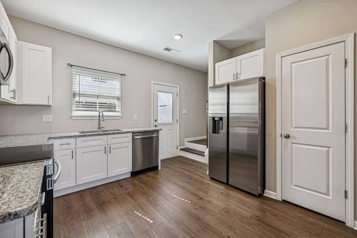 Open Kitchen with, granite coutertops, stainless steel appliances, custom cabinetry, LVP hardwoods throughout the home. Refrigerator stays