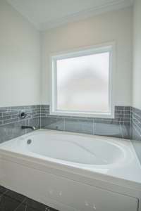 Garden Tub with Tile Surrounding and Frosted Window! Perfect for Relaxing!