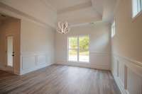 Spacious Dining Area with Beautiful Wainscoting and a Double Tray Ceiling!