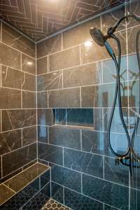 Fully Tiled Shower with a Bench and Built-in Shelving!
