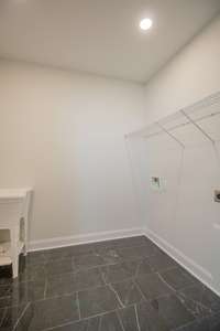 Large Laundry Room with Tile Flooring, Cabinets and a Utility Sink!