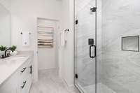 Floor-to-ceiling tile and frameless doors are featured in primary bathrooms. *Photos are of previous model home of the same floor plan with different finishes and are for representational purposes only.*