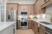 L shaped kitchen provides plenty of cabinet space *Photos are for representational purposes only and are of a similar floor plan with differing finishes*