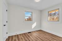 One of the 3 secondary bedrooms.  Overlooks the back and side yards.  More new flooring, paint, lighting, doors and door hardware.  Perfect for guest or kids.