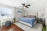 Primary bedroom with a large walk in closet and an en-suite bathroom. All laminate flooring flows into the bedrooms.