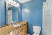 Primary bathroom with tile floors AND a great tile shower!  Granite counter tops with extra counter space or enough room if buyer wants to add a second sink.