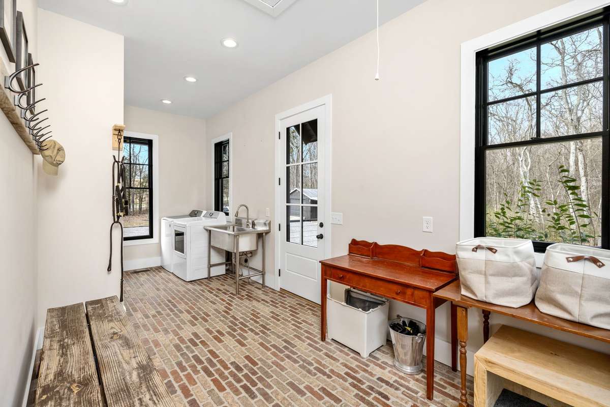 See the backyard that backs up to acres of woods. This backdoor is one of 7 entry doors into the home. The flow of this house is just incredible and you have not even seen the guest wing yet!