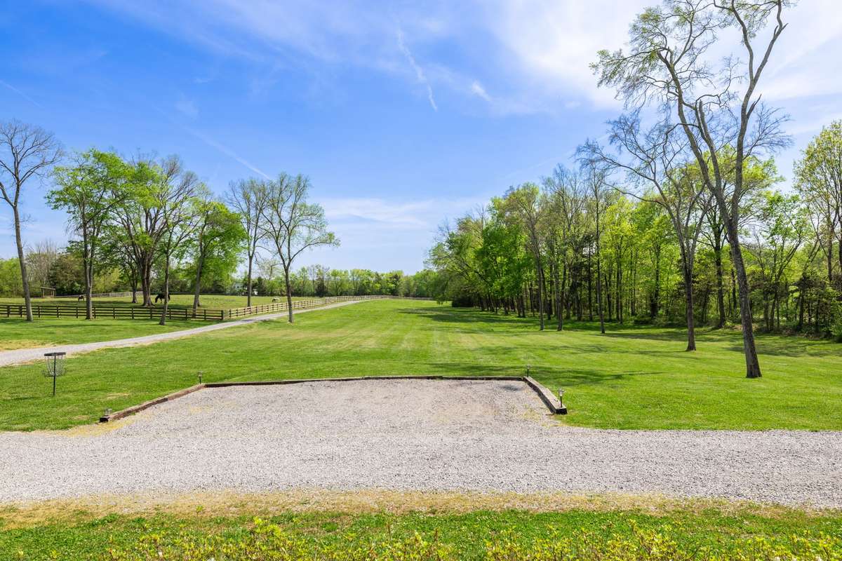 Open views from the front porch with huge trees and open pastures.