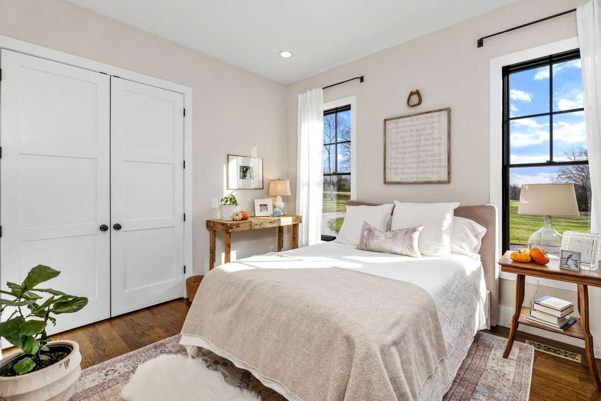 Welcome to the Guest Suite with ensuite bathroom. Every bedroom has their own private, full bathroom. The closet also features built-in shelves and solid wood shelving. Huge windows frame this room and re-energize guests for their stay.