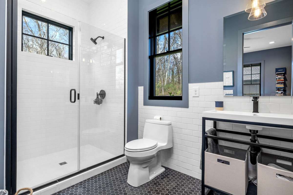 This bathroom also has hidden storage behind the door and walk-in laundry storage and more shelving