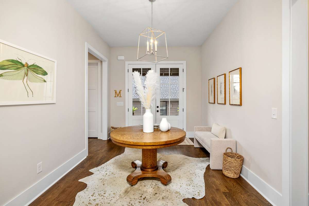 Welcome to the back foyer across from the detached garage. Huge double doors welcome you into the home from the extra-wide back driveway.