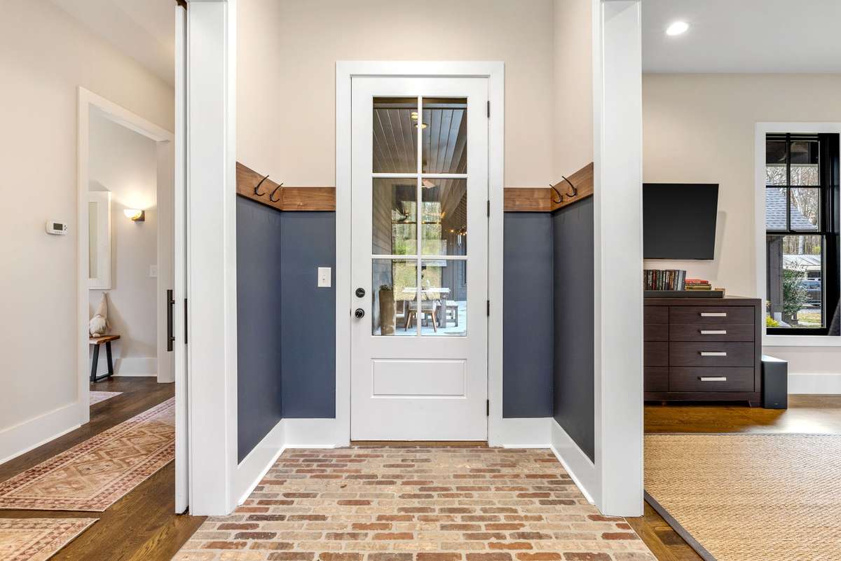 Between the Guest Suite and Bedroom 3, you find the breezeway.  This connects the courtyard to another side door, one of 7 entry doors, maximizing the flow of the house. This flooring is also waterproof, as it leads to the pasture.