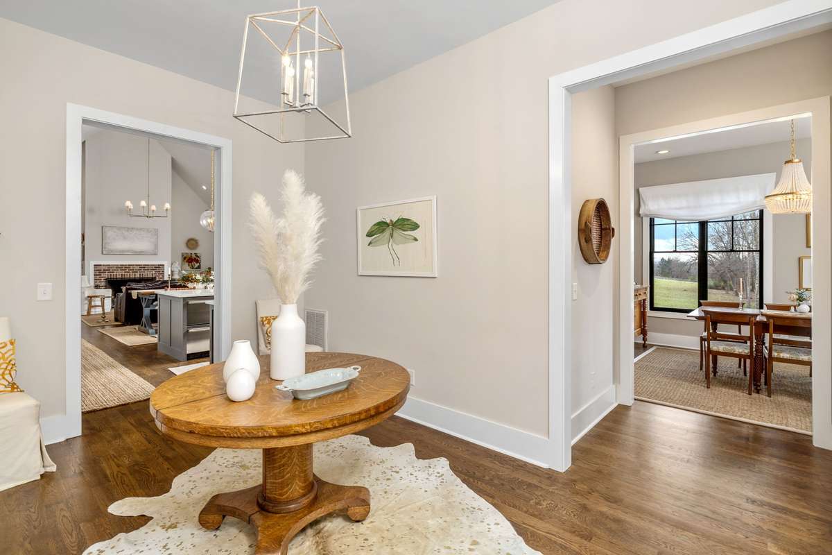 Here is another view as you enter the foyer from the side entrance. See the Formal Dining Room on your right, the Great Room straight ahead, and the owner's wing to the left.