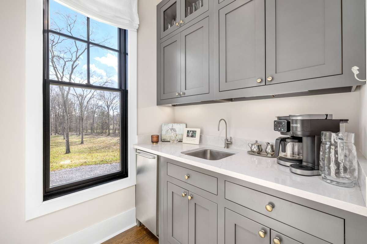 The skullery is bathed in natural sunlight. Perfect for a coffee bar with filtered water on tap and professional ice machine in the cabinetry.