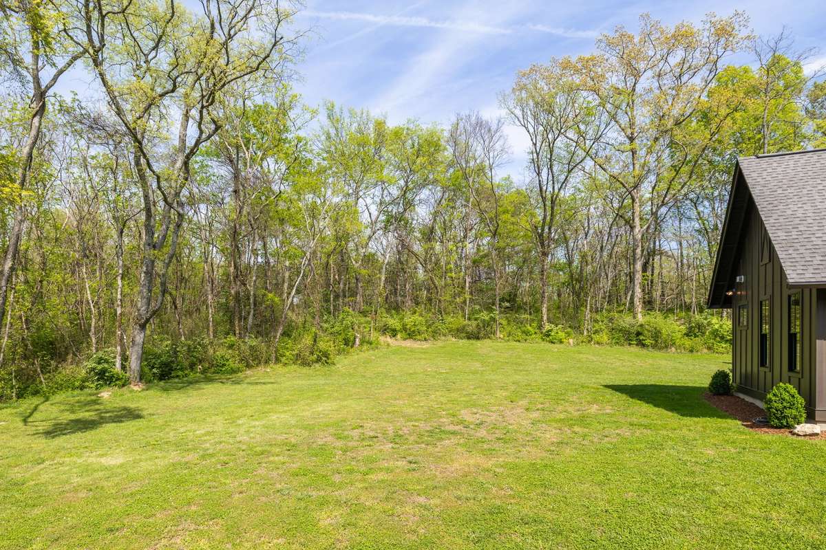 The backyard opens to acres of woods and quiet nature