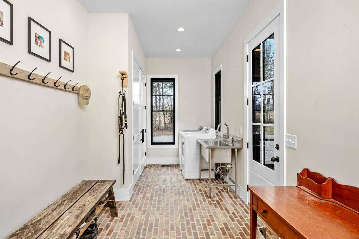 This is the pefect spot to put on your boots and riding gear. There is another room like this on the guest wing too. Across from the laundry machines is a gigantic, double door, storage closet.