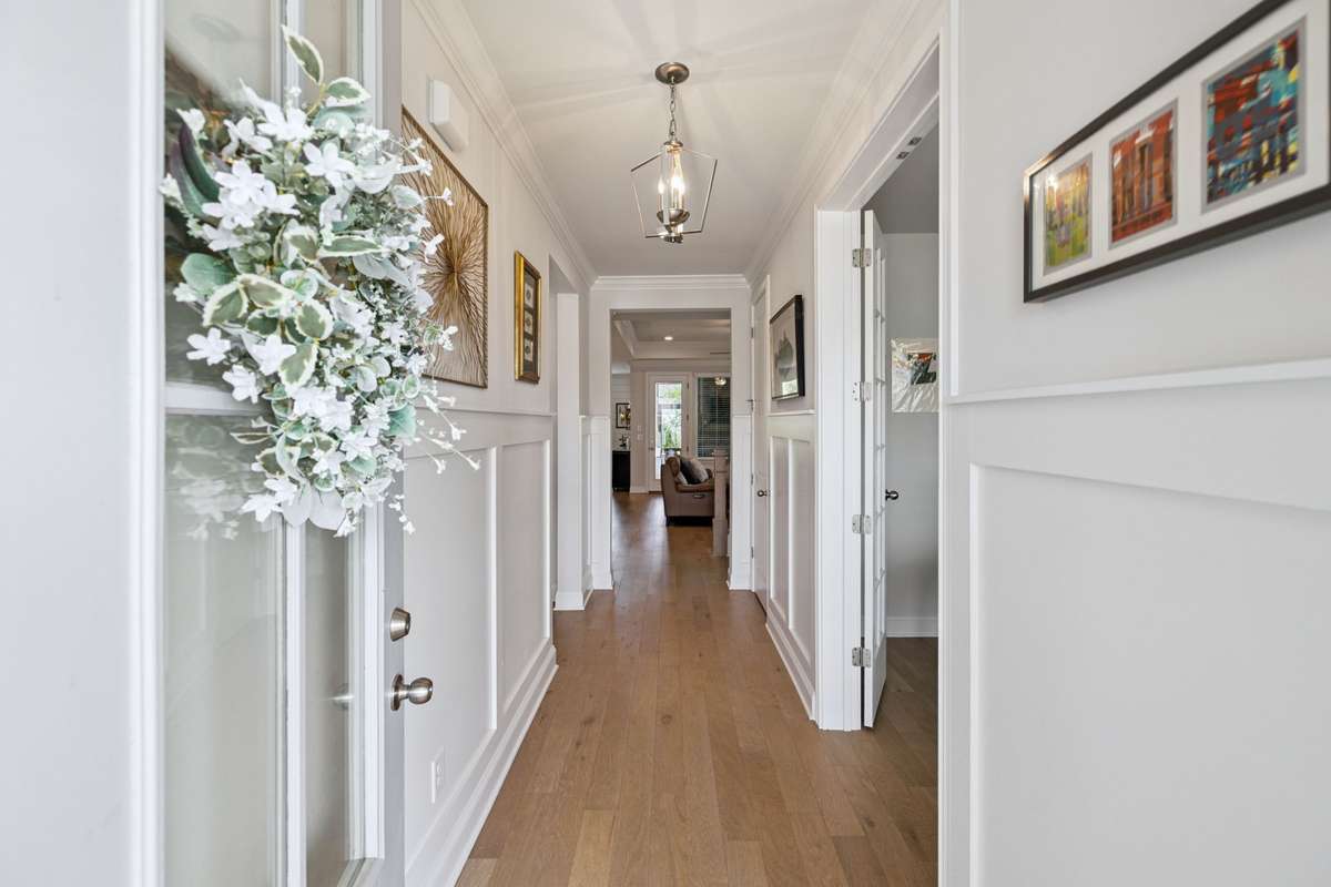 The welcoming foyer includes judges paneling, soaring ceilings and views all the way to the back porch.