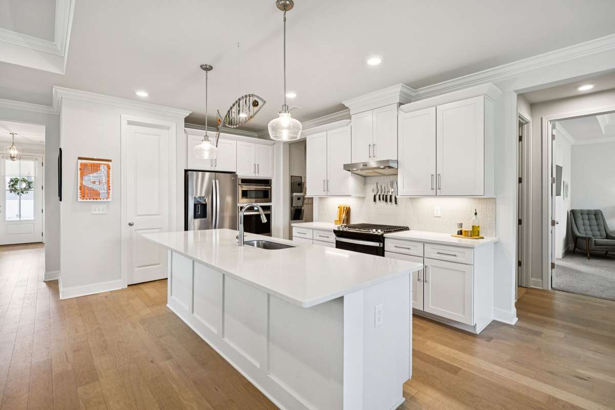 Another view of the kitchen island. The cased opening hall on the right in this picture, leads to the primary suite.