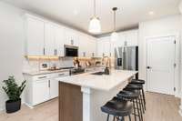 Eat in island is ideal for additional seating. *Photos are of a similar floorplan with differing finishes.*