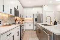 Stunning kitchen with designer appointed finishes and top of the line appliances  *Photos are of a similar floorplan with differing finishes.*