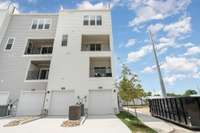 View of rear garage and Primary covered porch.  *Photos are of a similar floorplan with differing finishes and elevation.*