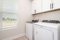 Laundry room  *Photos are of a similar floorplan with differing finishes.*