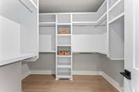 Primary walk-in closet *photos are of a similar floor plan with differing finishes and are for representational purposes only*