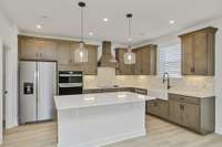 Open concept chef's kitchen! Photos of example home only, build with your design features on your lot!