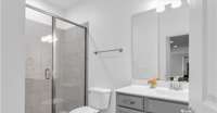 Full bathroom located in the hallway between both second and third bedroom with a walk in tiled shower