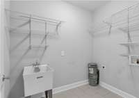 Walk in laundry room with shelves... and a sink!