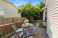 Deck off the side of the house.