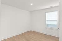 Another cozy bedroom, where warmth and comfort create the perfect space. The room features a large walk-in closet for your belongings.