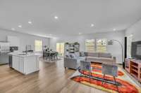 The great room is bright, open, and welcoming, filled with natural light that pours through large windows. Its open-concept design creates a seamless flow that's perfect for gathering with family and friends.