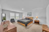 The modern and spacious owner’s suite is a true retreat, filled with abundant natural light.