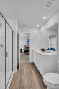 The beautiful, modern owner’s suite features an en-suite bathroom with double vanities and a  walk-in shower, creating a perfect blend of style and comfort.