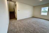 Living space leading into office space and stairway