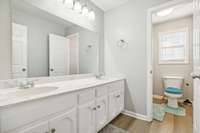 Updated bathroom with double vanity and abundant storage.