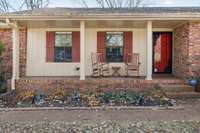 Charming front elevation with a rocking chair porch, perfect for morning coffee or evening relaxation.