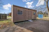 Backyard storage building for tools, hobbies, or extra space.