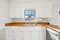 Spacious kitchen with double sink overlooking the backyard, perfect for multitasking.