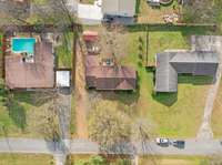 Aerial view highlighting home’s spacious lot in a quiet neighborhood.