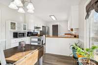 Bright kitchen with abundant cabinetry and classic white finishes.
