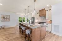 Deluxe kitchen with oversized island, solid wood cabinets with soft-close hinges, and beautiful backsplash.