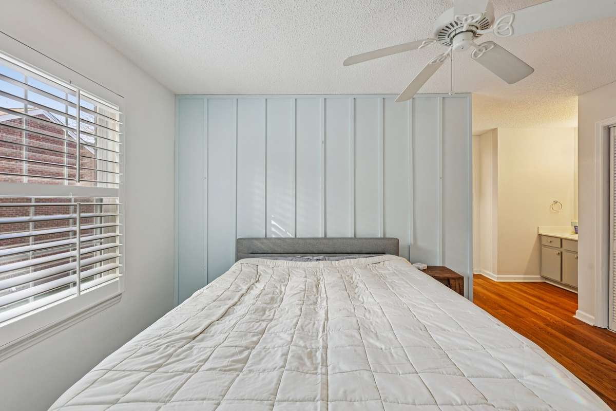 Large window with plantation shutters and board-and-batten wall add charm and character.