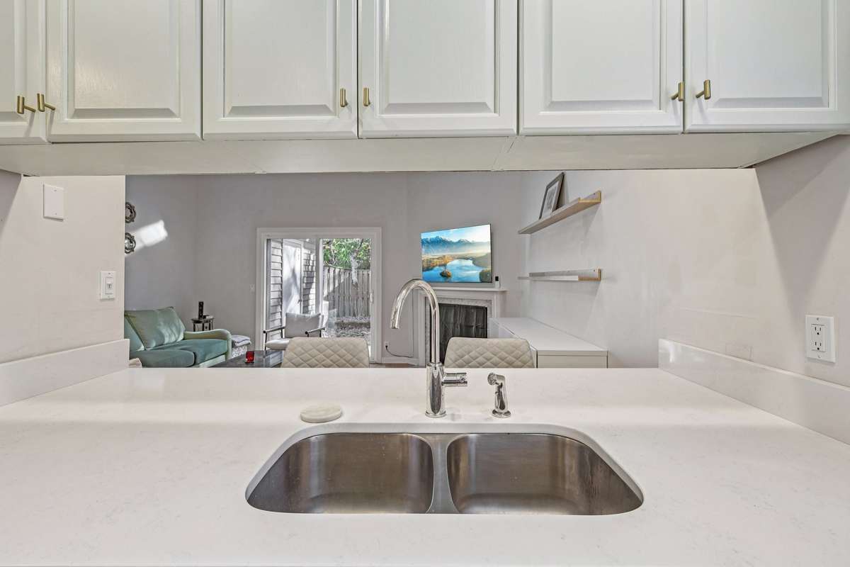 Open sightlines from the kitchen to living and outdoor space, giving this home a spacious and connected feel.